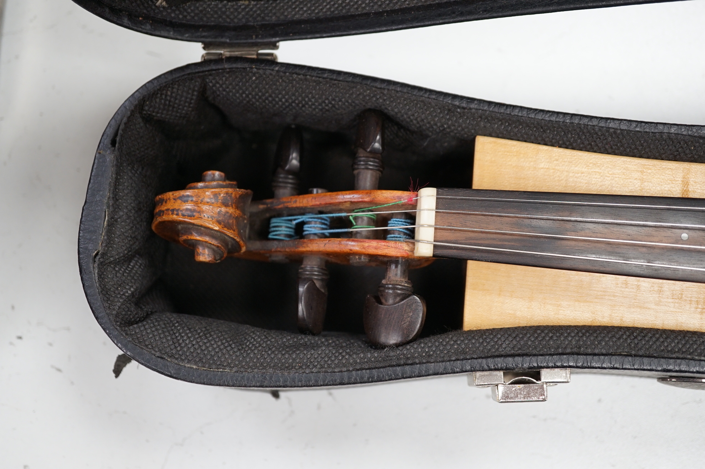 An unusual travelling violin (Pochette), length of body, 25.5cm, with standard length neck, with shorter 53.5cm bow and fitted case, overall length of violin 55cm